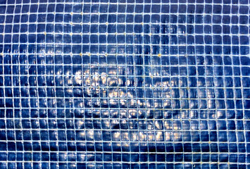 A fragment of an old polycarbonate film close-up on a summer day