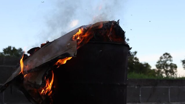Dumpster Fire Large Orange Flames Lick Out of Trashcan Fire