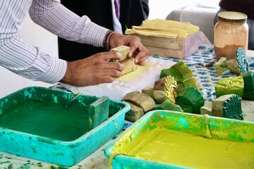 Handmade printed fabric cotton, showing process hand block printed pattern on textile with natural colors, green, yellow