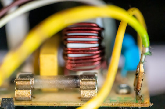 Brown damaged fuse that has blown and defective.