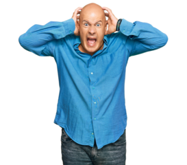 Middle age bald man wearing casual clothes crazy and scared with hands on head, afraid and surprised of shock with open mouth