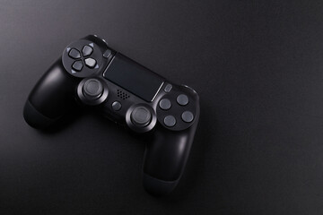 Black video game controller, joystick for game console isolated on black background. Gamer control...