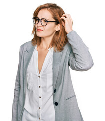 Young caucasian woman wearing business style and glasses confuse and wondering about question. uncertain with doubt, thinking with hand on head. pensive concept.