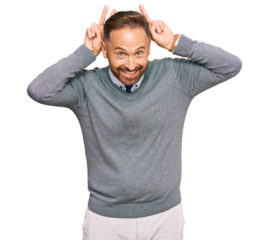Handsome middle age man wearing business clothes posing funny and crazy with fingers on head as bunny ears, smiling cheerful