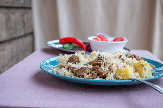 A plate of Kenyan pilau shot at table level.