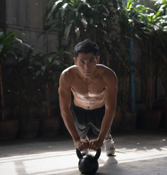 Young man with fit and firm muscle