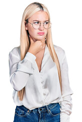 Beautiful blonde woman wearing elegant shirt and glasses touching painful neck, sore throat for flu, clod and infection