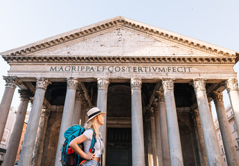 Young girl walks exploring the city with her backpack on a sunny day, digital nomad