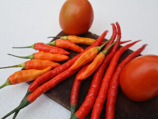 chilies and tomatoes on the cutting board isolated 
