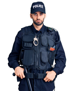 Young handsome man with beard wearing police uniform depressed and worry for distress, crying angry and afraid. sad expression.