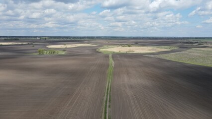 Fototapeta premium Aerial top view photo from flying drone of a land with down fields in countryside.