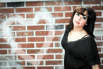 portrait of a woman near a brick wall, heart 