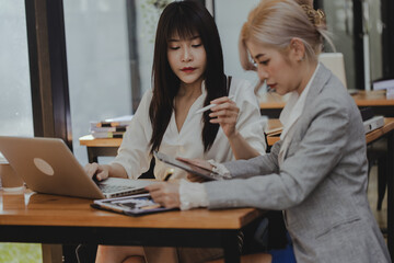 Technology and financial advisory services concert. Business teamwork and working on digital laptop computer with advisor showing plan of investment to clients at table office. Digital marketing.