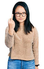 Young chinese woman wearing casual sweater and glasses showing middle finger, impolite and rude fuck off expression