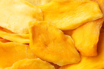 Heap of dried mango as a background. Copy space, close up.