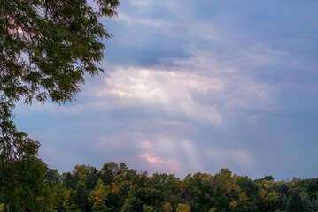 Sunny Colored Rays Shining Through Storm Clouds