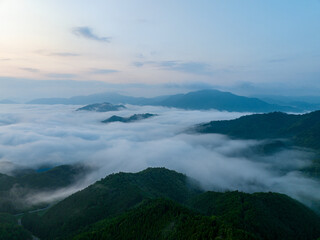 Flowing fog amid mountain peaks at dawn