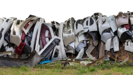 Isolated pieces of front bumper scraps, which were collected from the garage and dumped on grassy ground.