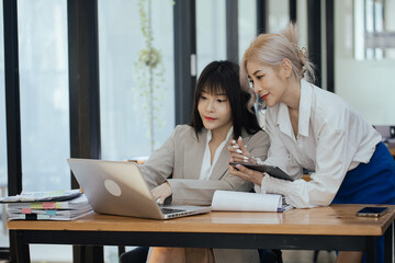 Businesswoman team working with finance marketing, Business teamwork, working on digital laptop computer at table office, business accounting and financial planning concept.