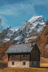 Fototapeta na wymiar mountain house in front of a landscape of a village view in the mountains at autumn on a sunny day