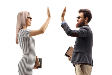 Woman holding books and gesturing high-five with a man