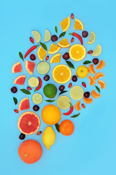 Citrus fruit and chilli peppers with leaves. Abstract design of healthy food high in bioflavonoids that fight free radicals, polyphenols, antioxidants, vitamin C, flavonoids and anthocyanins. On blue.