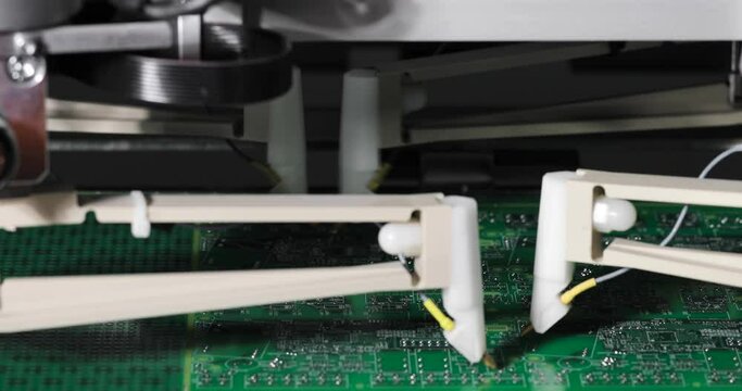 Needles touch the microcircuit in machine for automatic testing of electronic boards. Process of manufacturing production of microcircuits and microprocessors. High-tech technologies.