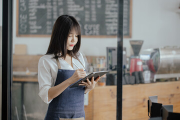 Asian business woman cafe owner. Successful owner standing at cafe shop.	