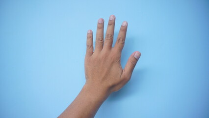Hand extended in greeting isolated on blue background. Number five.