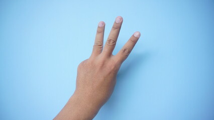 Hand extended in greeting isolated on blue background. Number three.