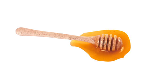 honey dripping from a wooden dipper