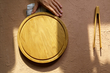 Empty wooden dishes, kitchen utensils on a brown background. Eco-friendly tableware. Top view.