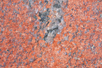 Background texture of polished red granite, close-up.
