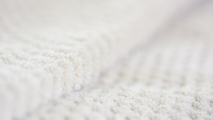 Fototapeta na wymiar Soft white fabric texture textile material selective focus blurred background.