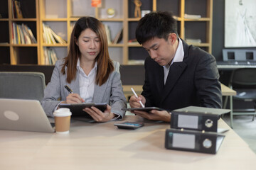 Person analyzing figures, Two businessman working on tablet and new startup marketing idea presentation, Business meeting discussion startup concept.	
