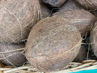 Coconuts background on the market, fruit sale. Food market. Selective focus