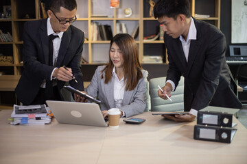 Technology and financial advisory services concert. Business teamwork and working on digital laptop computer with advisor showing plan of investment to clients at table office. Digital marketing.