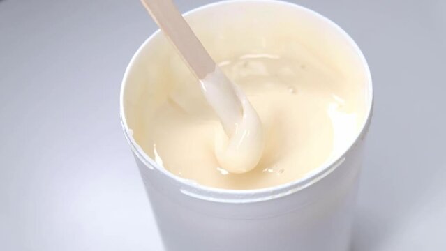 Sugar paste for depilation stirred with a wooden spatula