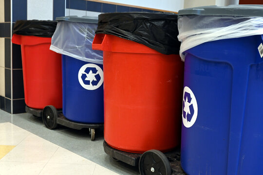 Regular and recycling garbage bins lined up in big building. Custodial cleaning routine in corporate environment