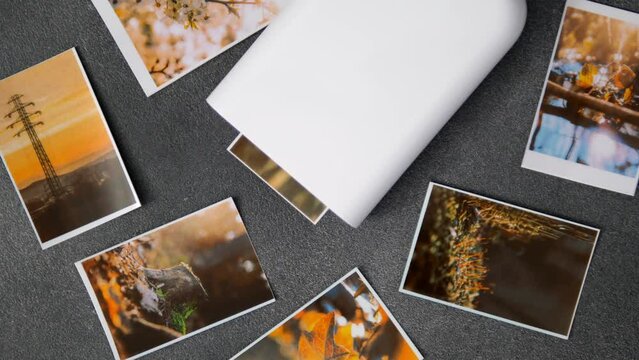 Proccess of printing photo with portable printer at home. Wireless mini printer for smartphones. Small prints for a photo album