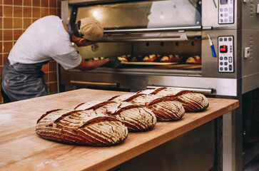 Male baker near oven in bakery
