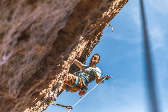 climber hanging on cliff