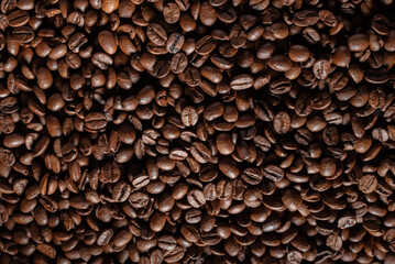 Rotation and approaching of coffee beans in a clay pot, standing on the background of coffee beans.