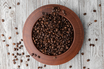 coffee beans in a plate on a white table