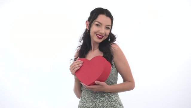 Happy Smiling female sen air kiss. young woman hold a Heart shaped Gift Box. Valentine's day Romantic concept joyful Gift