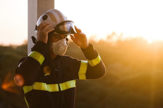 Firefighter getting dressed to start work disinfecting a buildin