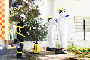 Firefighter disinfecting his colleagues' uniforms