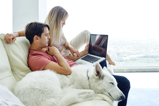 Couple having video call on computer at home