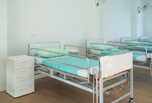 Empty Patient Beds In Ward In Nursing Home In Hospital Room In Medical And Health Care Concept