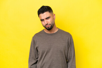 Young Arab handsome man isolated on yellow background with sad expression